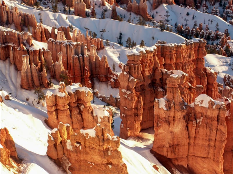 tall red rocks with snow on top