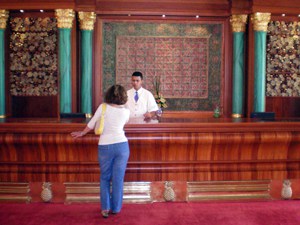 a hotel desk with green pillars