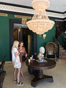 two young women by a chandelier