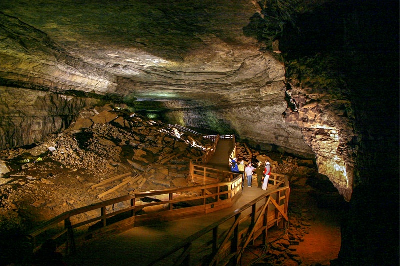 people on a tour in a large cave