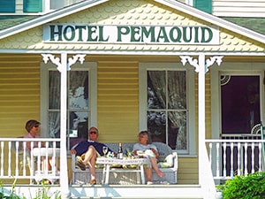 people on the front porch of a small hotel