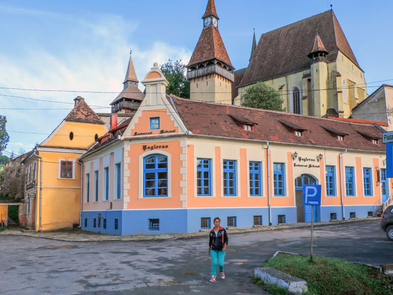 colorful buildings around a church on a hill