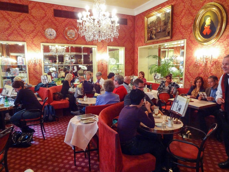 people at tables in a cafe decorated in red