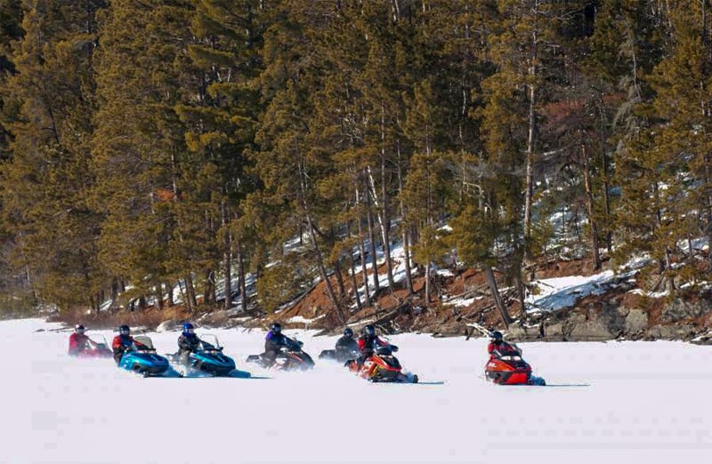 people on snowmobiles