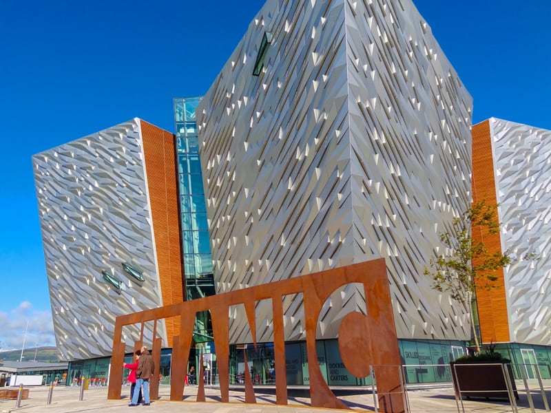 people at the front of a building made of stainless steel