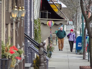 a couple walking down a street filled with shops