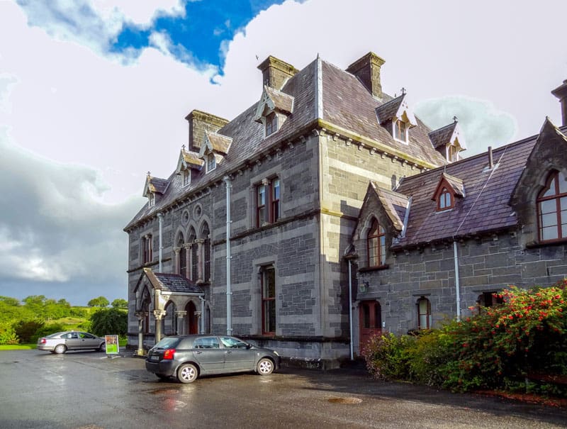 cars arked in front of an old museum building