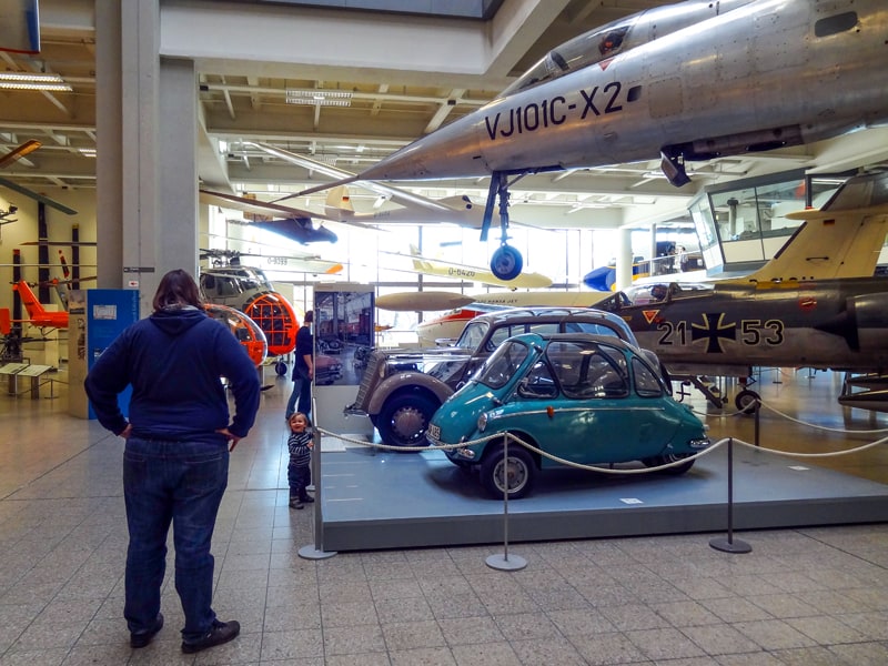 a child by an exhibit of small cars in the Deutsches Museum, one of the special European Museums 