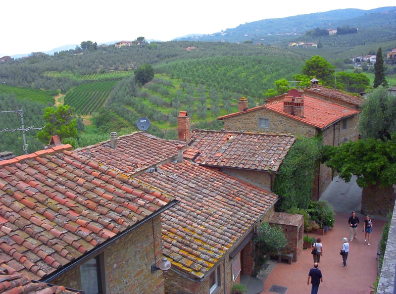 people walking along a street in a small Italian village