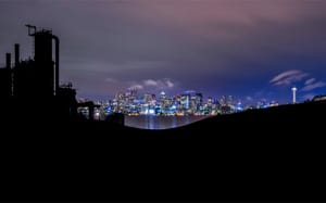 a city at night seen from an industrial tourism site