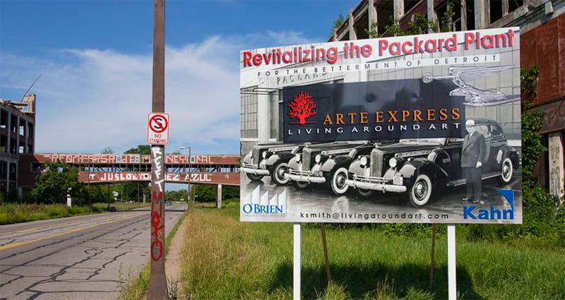 A large sign reading "revitalizing the Packard Plant," part of an industrial tourism effort