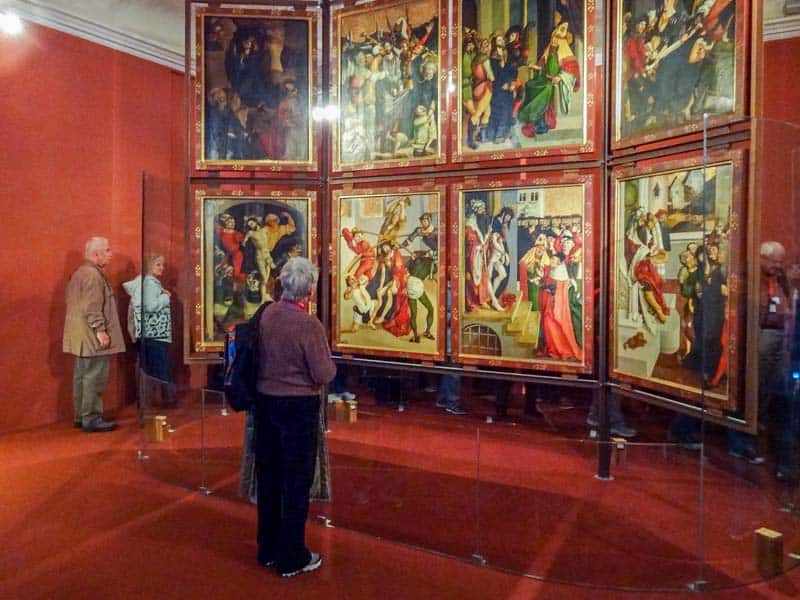 a woman looking at paintings in Melk Abbey