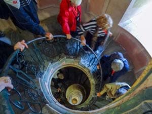 people walking down a spiral staircase