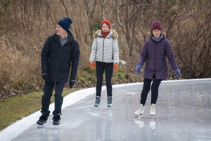 3 people ice skating