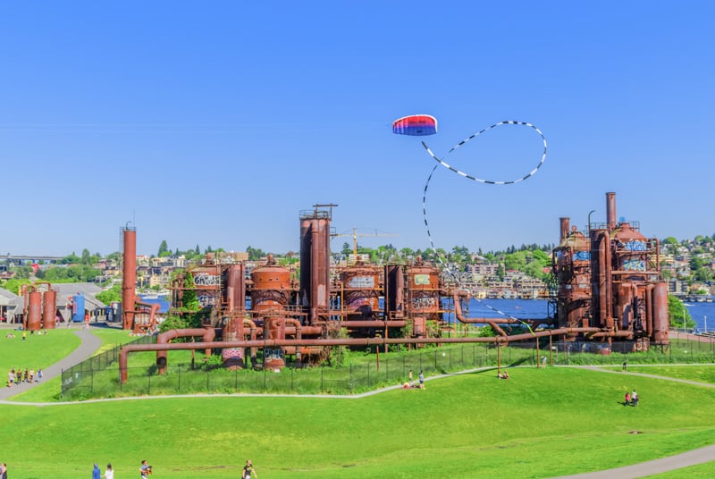a kite flying over an old industrial park