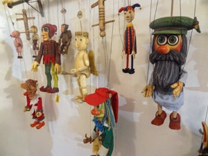 Marionettes hanging on a wall seen in a shop in Prague in winter