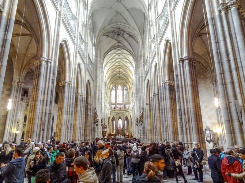 a crowd inside a large cathedral with a soaring roof see in Prague in winter