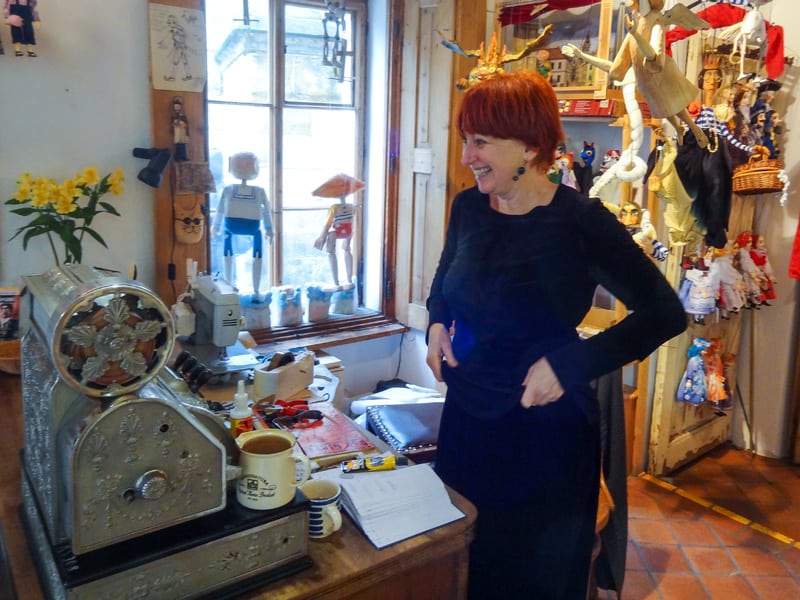 a smiling woman in a shop in Prague in winter