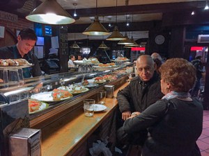 an older couple sitting in a bar