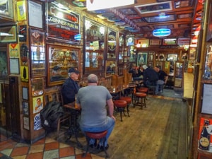 Men sitting in the Duke of York Tavern. Visiting it is one of the things to do in Belfast.