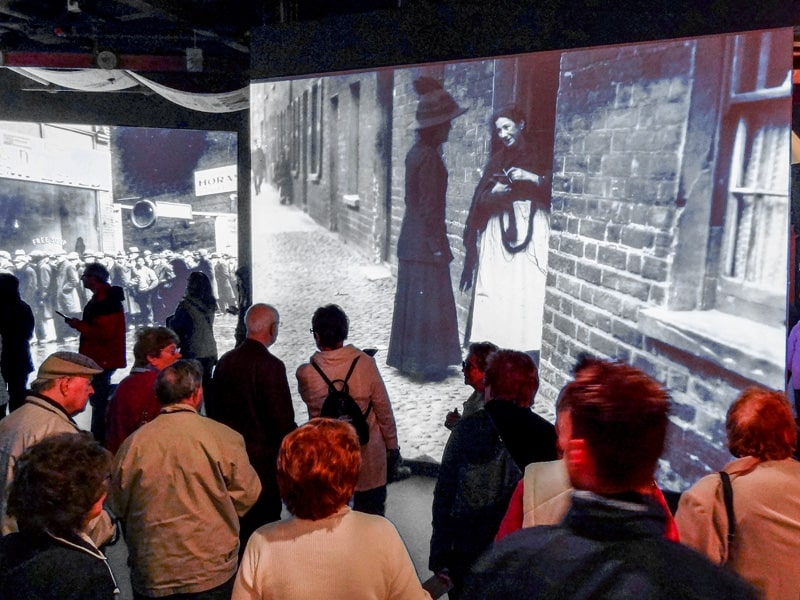 People touring through an exhibit in thee Titanic Museum, one of the best things to do in Belfast.