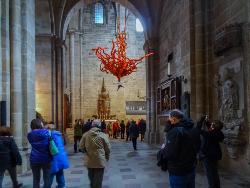 red glass artwork hanging in a large church