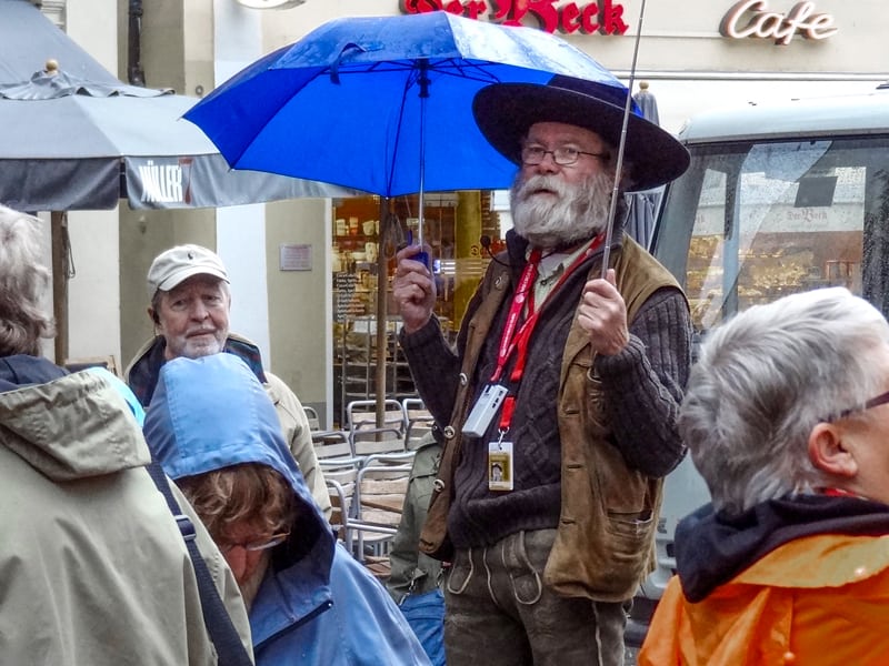 a man with a white beard holding an umbrella in Bamberg Germany