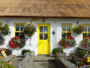 a cottage with a yellow door visited while staying at Ireland bed and breakfasts