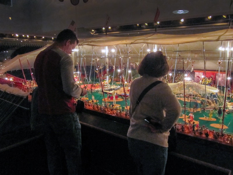 two people looking at an exhibit of a miniature circus