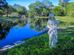 a statue by a lake