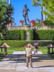 man taking a photo of a large statue