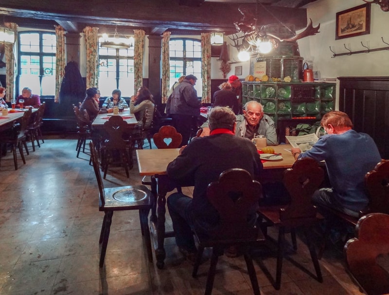 men sitting in a restaurant drinking beer