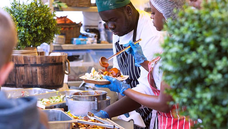 a chef preparing a meal at one of the food festivals in Europe 2023