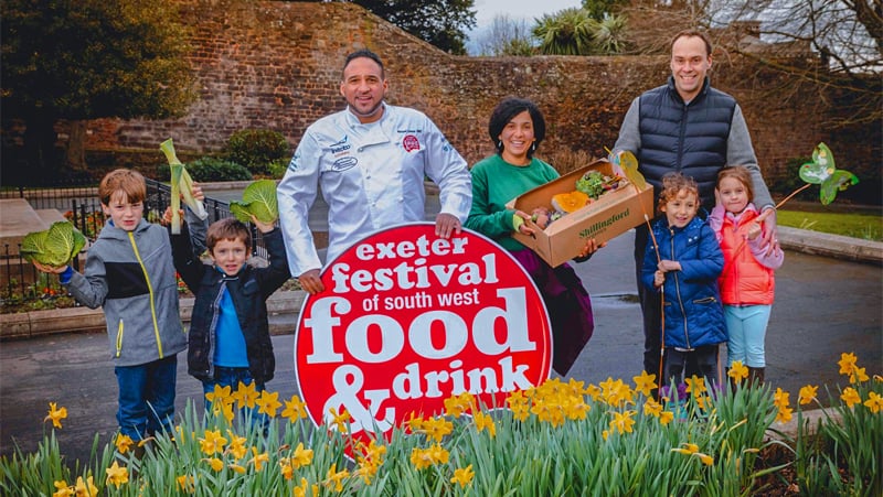 people holding a large food and drink sign