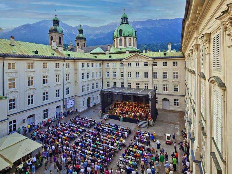 people attending a concert in the palace courtyard