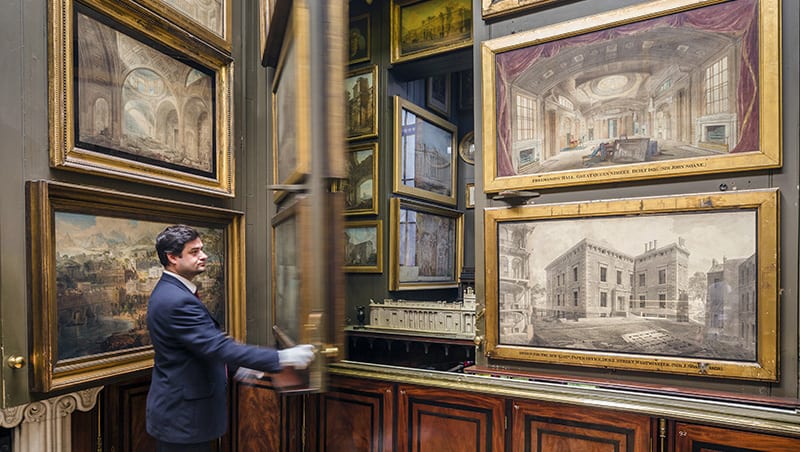 man looking at paintings in a museum - one of the free things to do in London