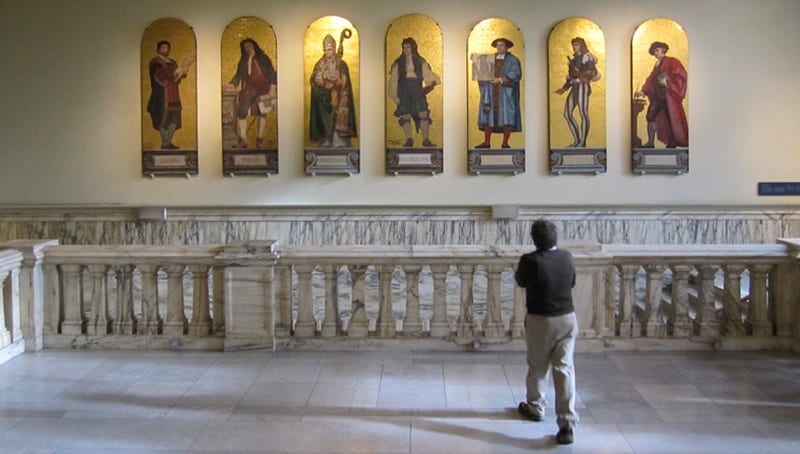 man looking at statues in a museum - one of the free things to do in London