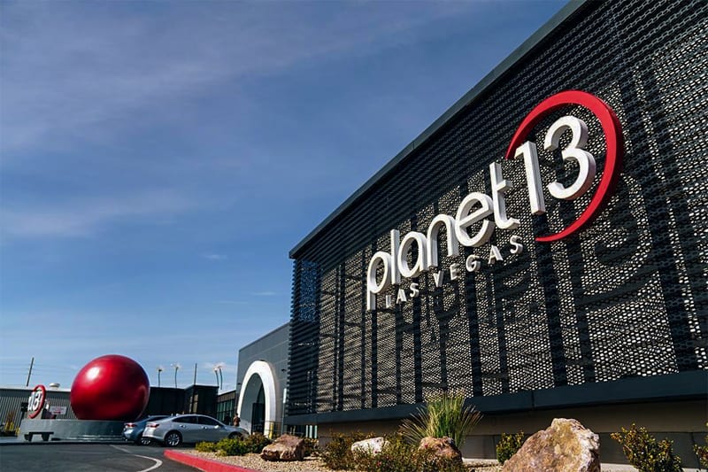 teh front of a building with a sign for Planet 13 on it