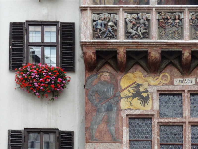 looking at paintings on old buildings - one of the things to do in Innsbruck
