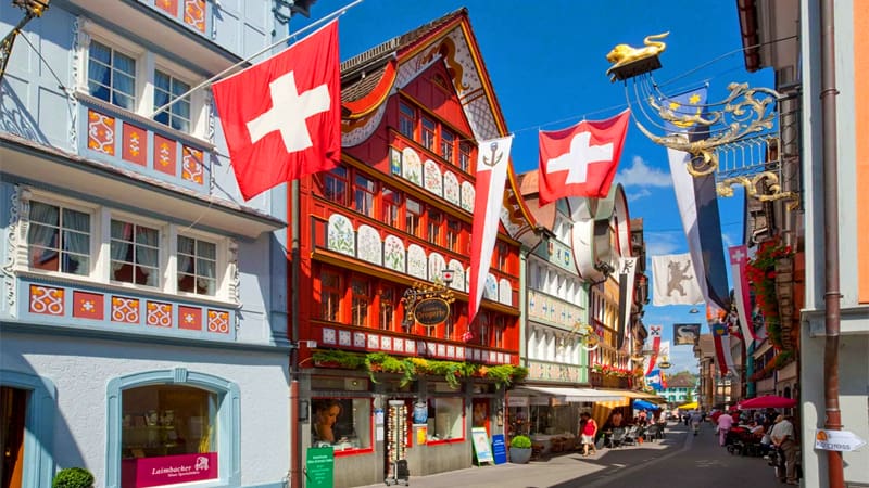 whoppers walking by colorful old buildings on a town street