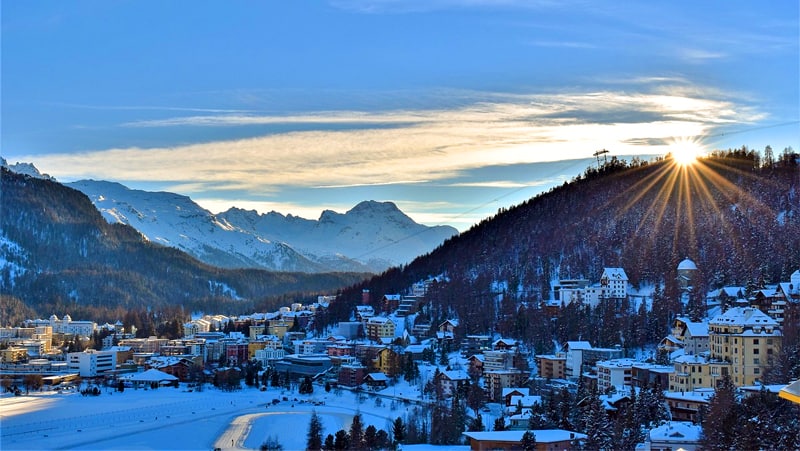 the sun setting over a mountain village