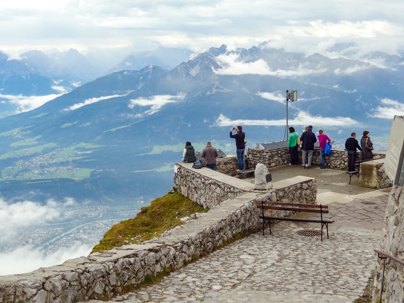 people on a lookout area high up a montain