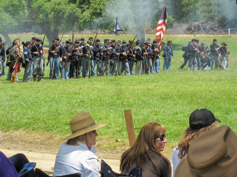 people looking at civil war soldiers during Civil War reenactments