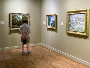a many looking at painting in a museum