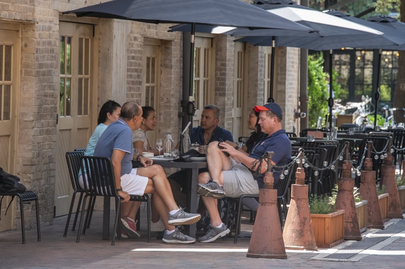 people in an outdoor cafe having drinks