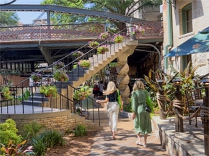 two women walking along a river – one of the things to do in San Antonio