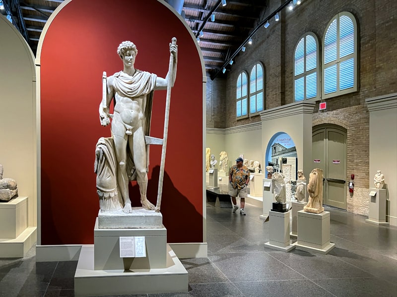 a man walking through a museum - one of the things to do in San Antonio
