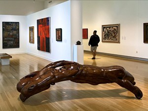 a man walking through an art museum - one of the things to do in San Antonio