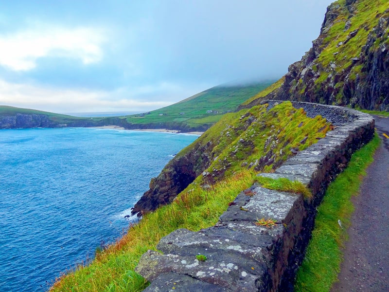 a roadway along cliffs plunging to the sea