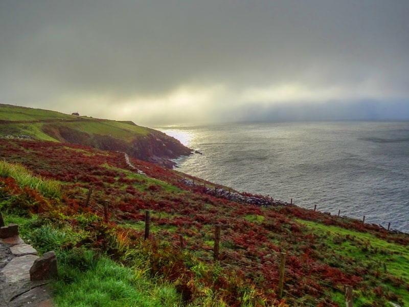 sun shining through the fog on a rugged coastline